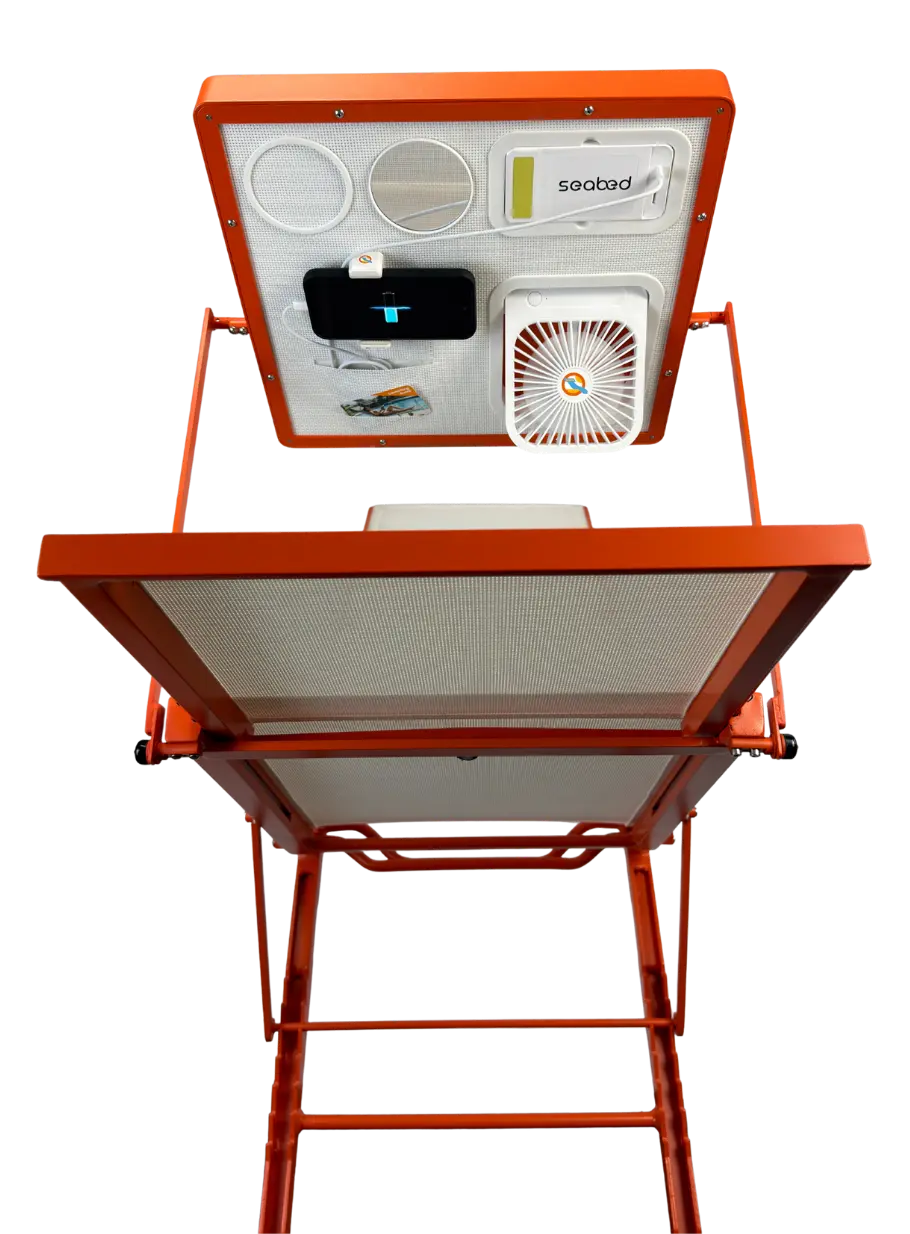 An orange and white outdoor patio lounger with a built-in fan, shown open against a solid white background. The adjustable shade features a built-in fan, a mirror, bluetooth speakers, and a phone charging port.